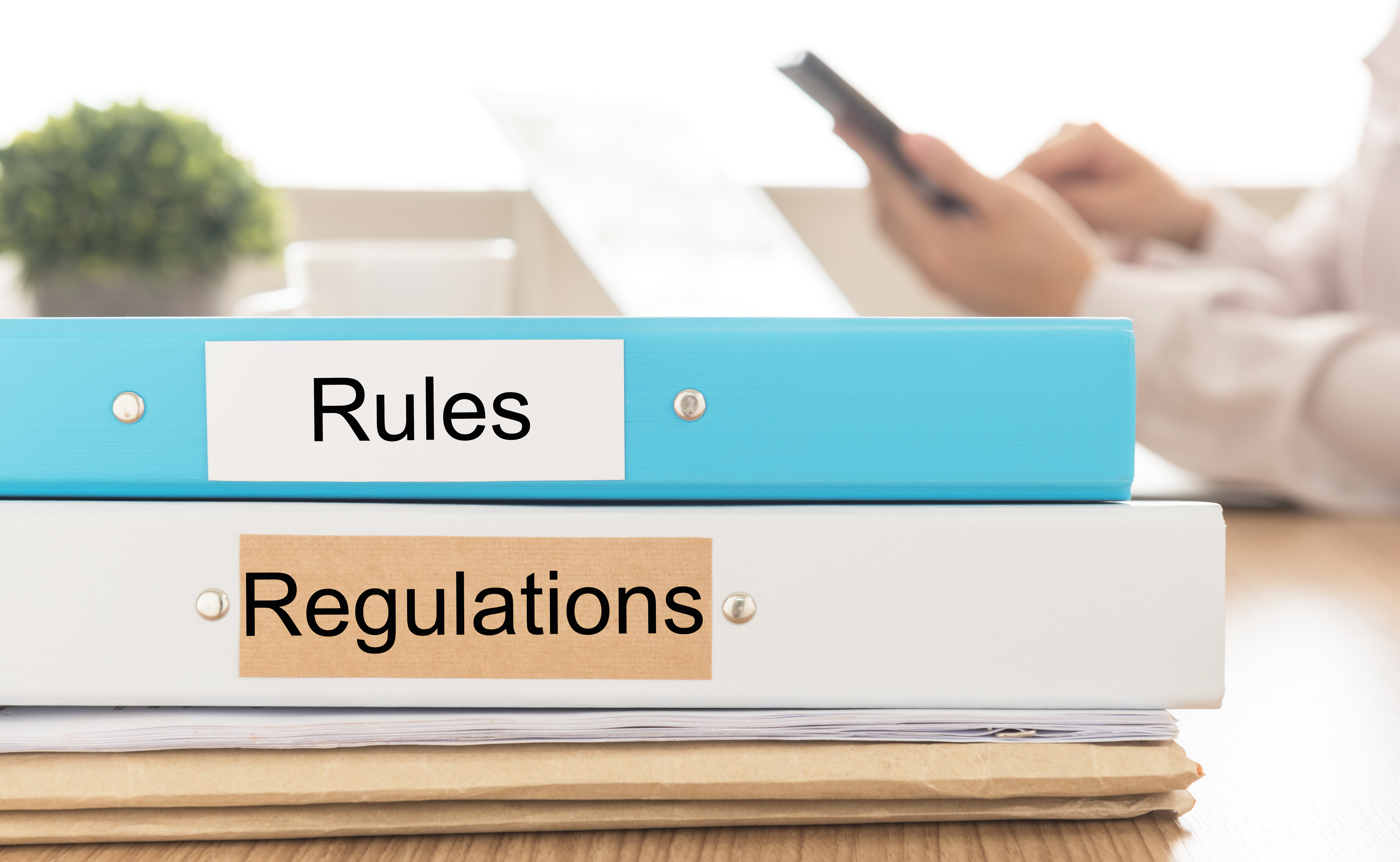 Binder labeled Rules and another labeled Regulations