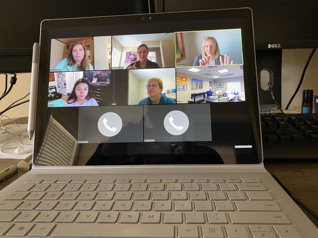 Zoom meeting with 6 participants on laptop