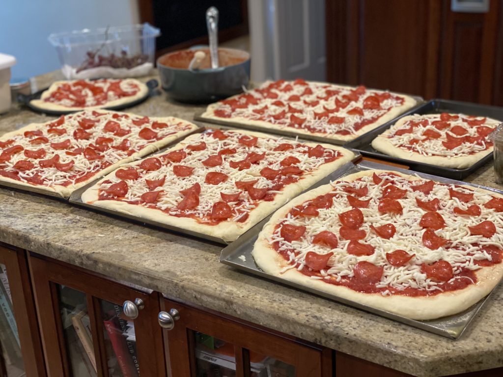 Homemade pepperoni pizzas on granite countertop 
